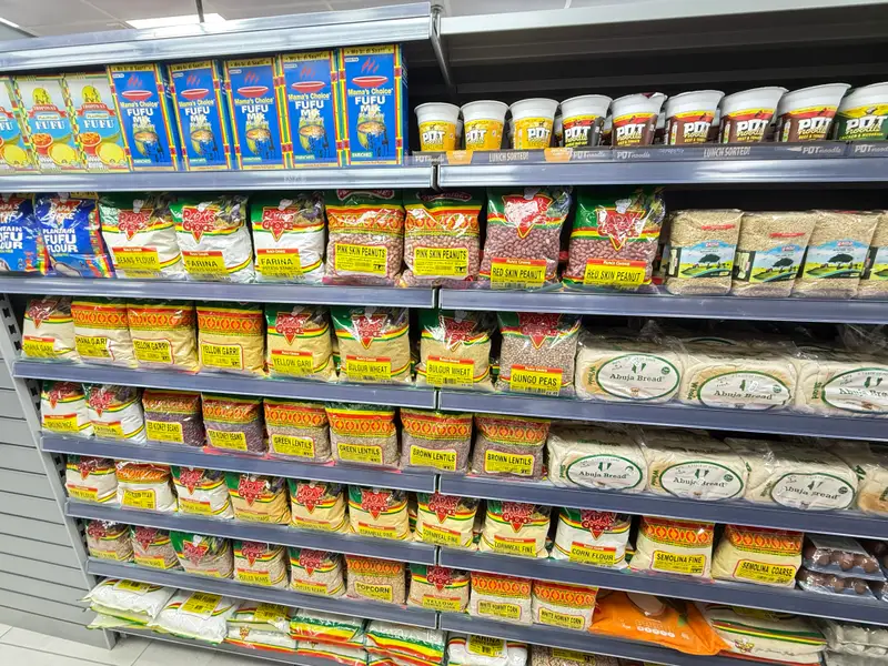 Shelves of grains, dried beans, lentils, flours and semolina, with fufu flour and instant noodles above